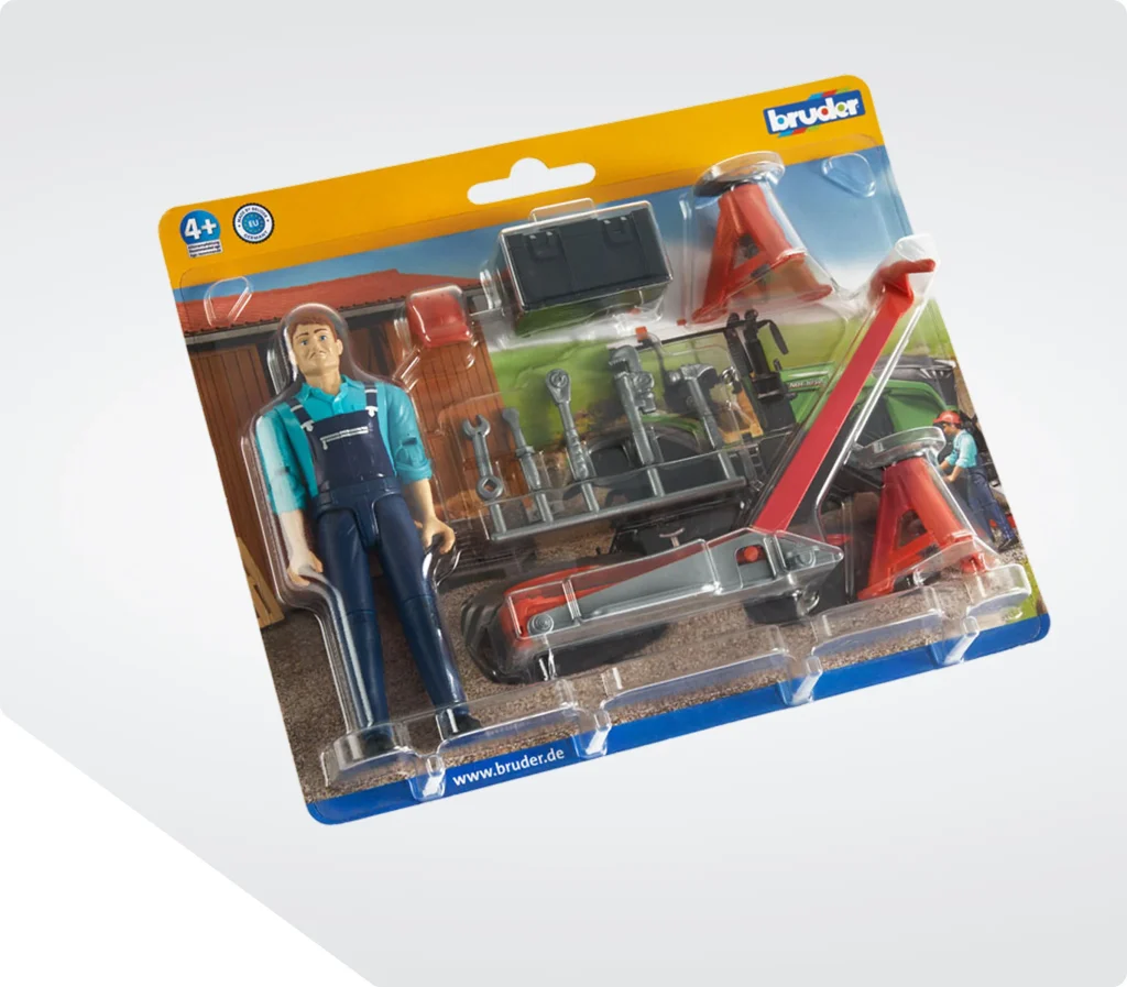 Blisterkarte mit tiefgezogenem Klarsichtblister, darin eine Spielfigur und Zubehörteile
